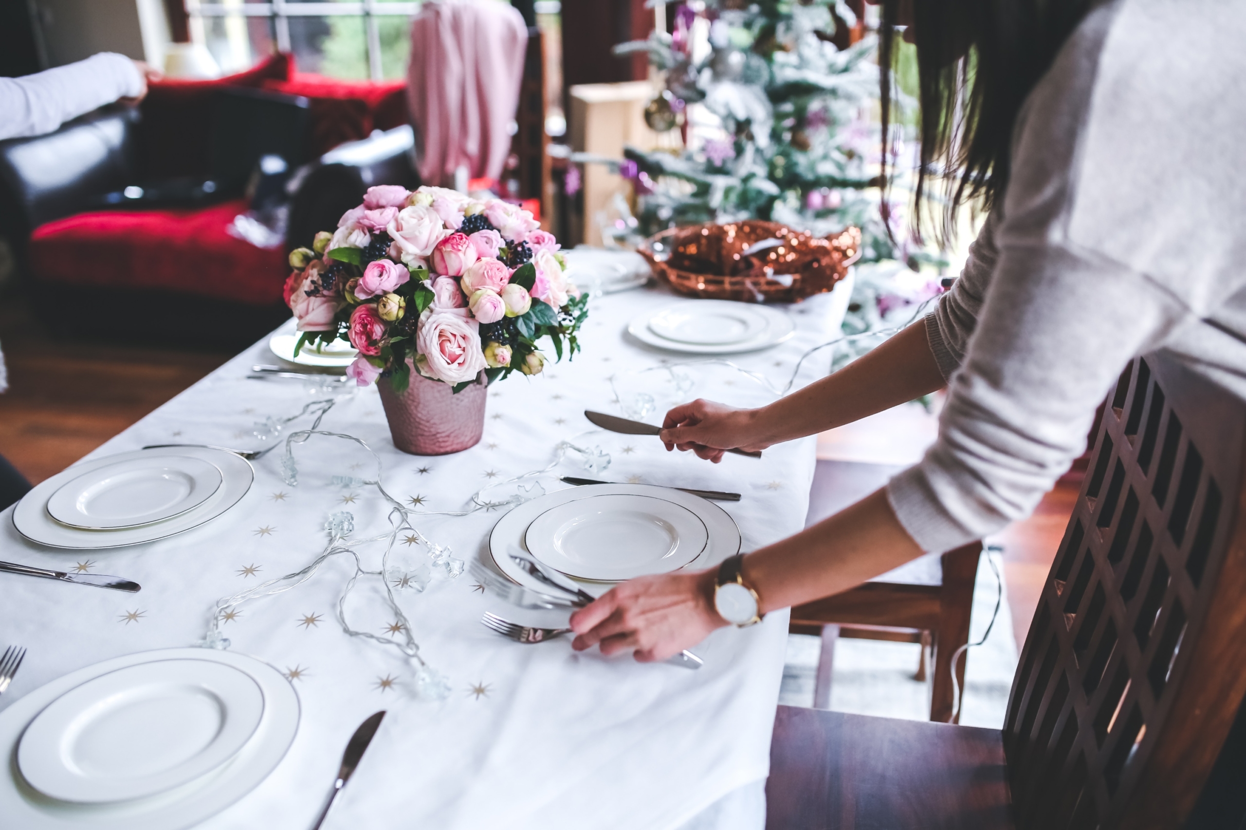 Woman setting dinner table for christmas party