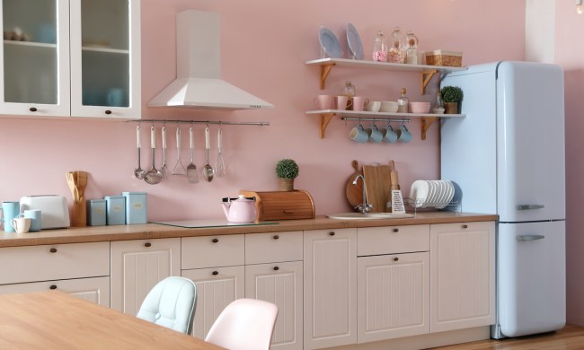 Stylish 1920's pink kitchen interior with dining table and chairs