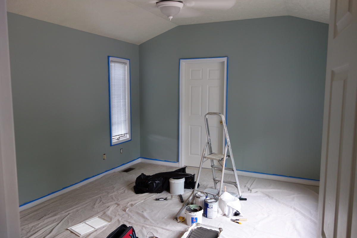 Bedroom with painting supplies on the floor