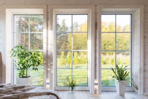 Three floor-to-ceiling windows with white trim.