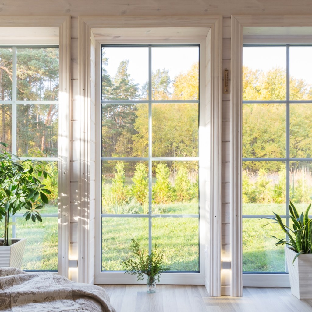Three floor-to-ceiling windows with white trim.
