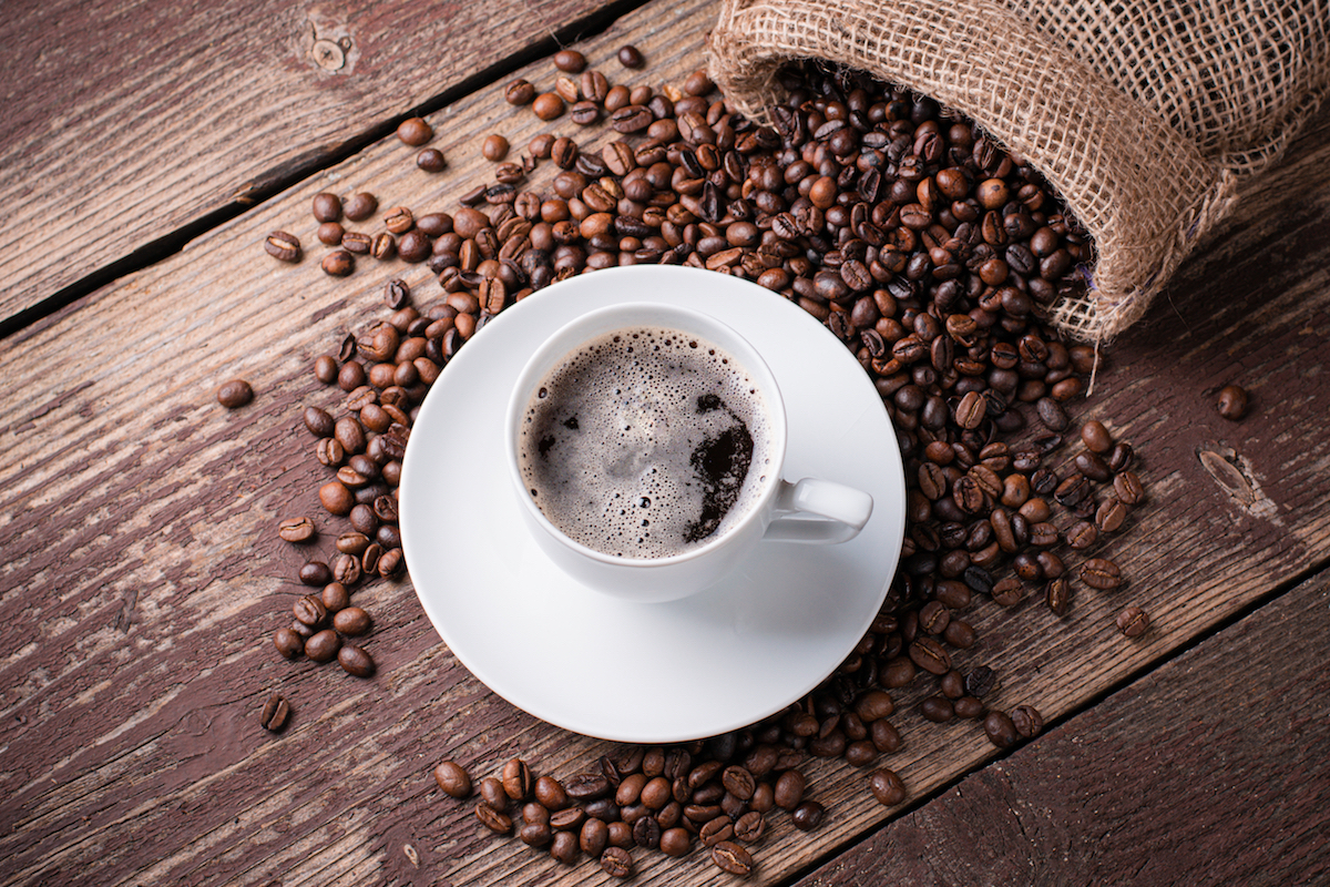 Cup of coffee on a pile of coffee beans