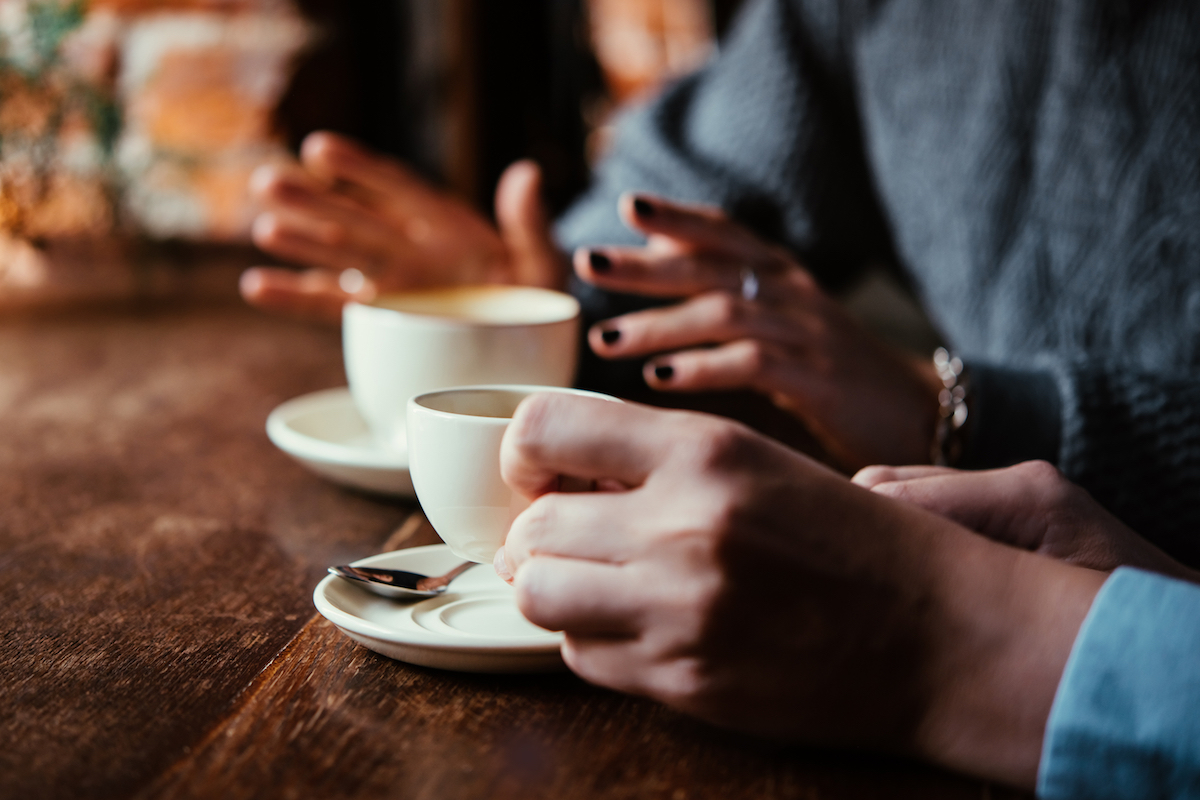 Two people with coffee at a cafe