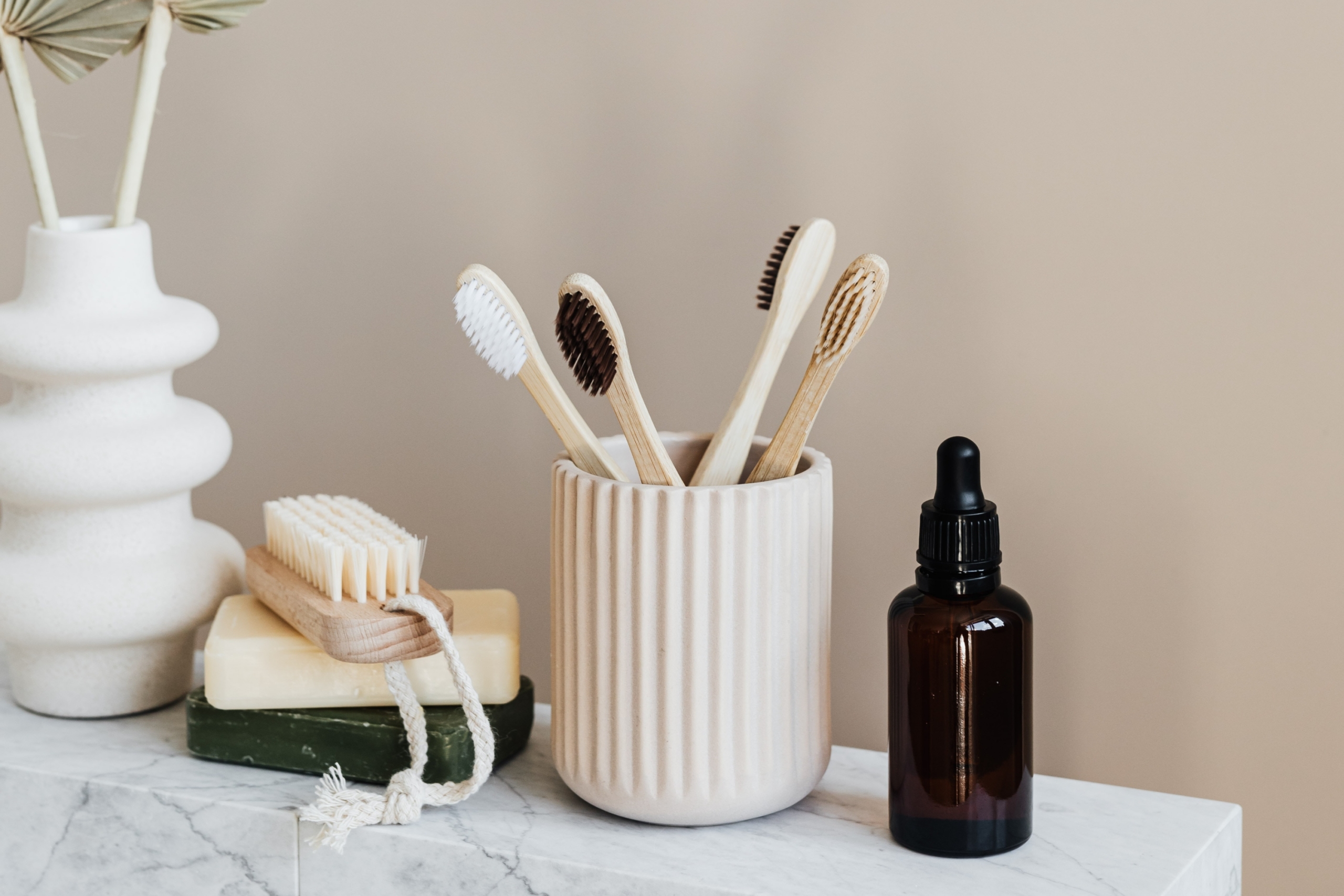 Brushes in a ceramic holder and soap on a shelf