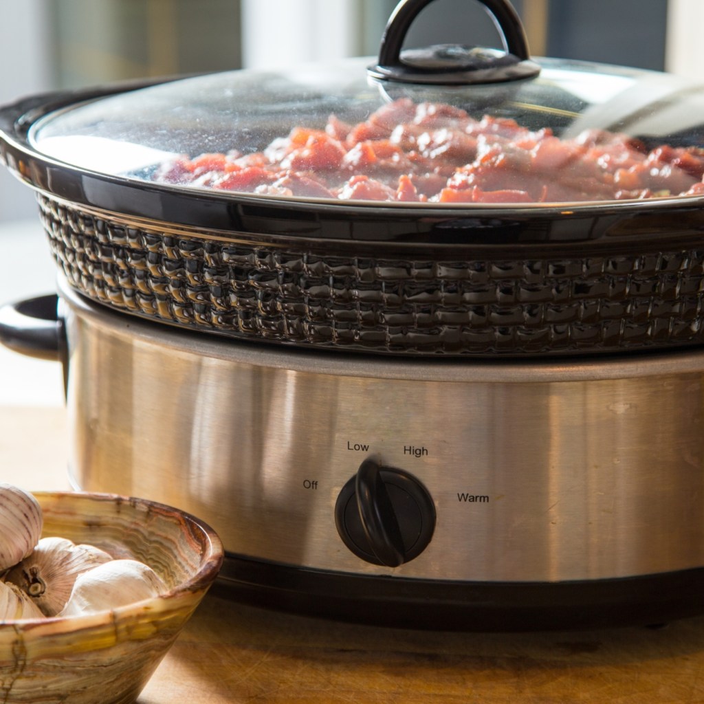 slow cooker on table with food