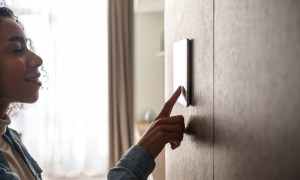Woman using smart home electrical unit