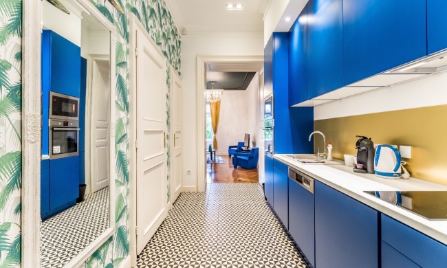 A galley kitchen with blue cabinets