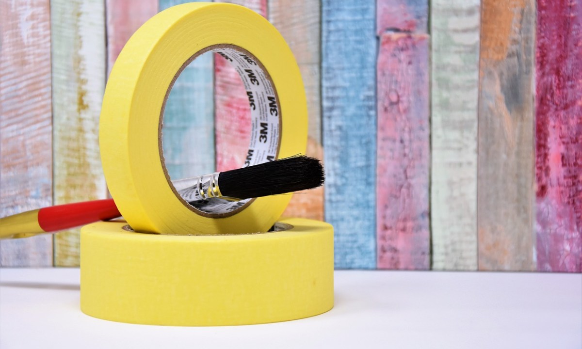 Yellow painter tape with red paint brush