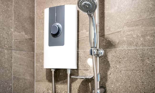 Tankless water heater next to a shower
