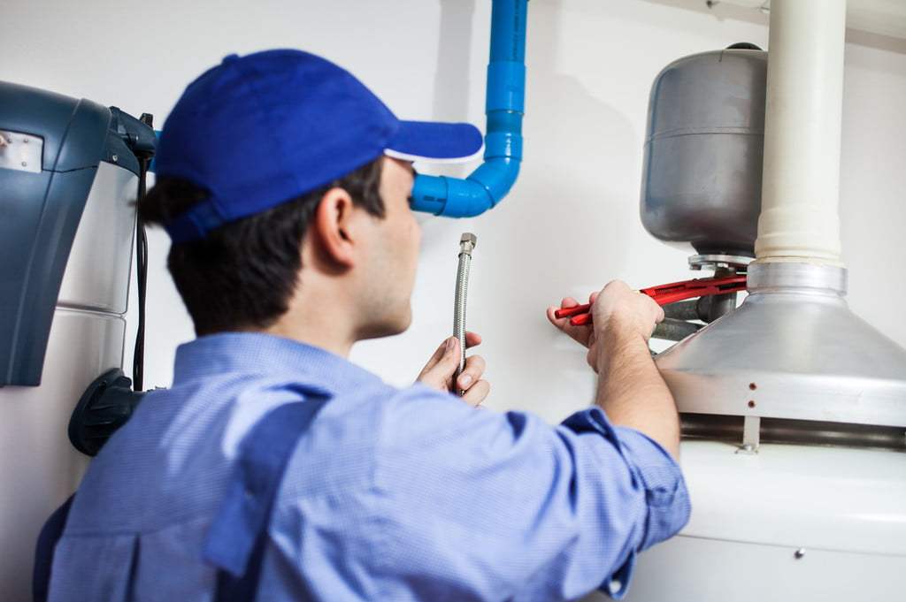 Worker looking at water heater