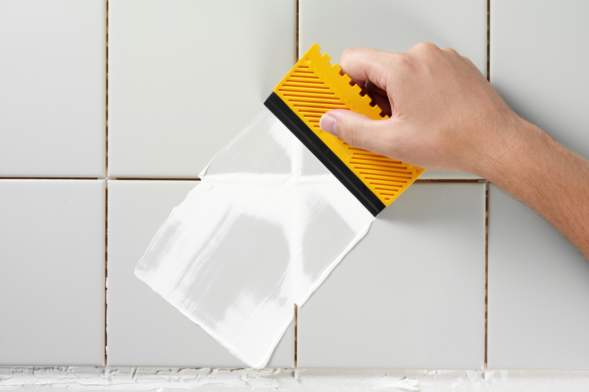 Applying new grout to white tiles