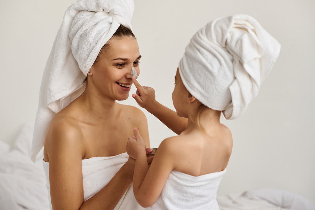 Mother and daughter in bath towels after shower