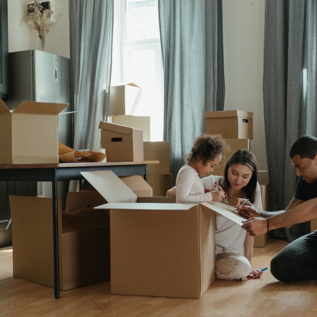 family packing boxes in living room
