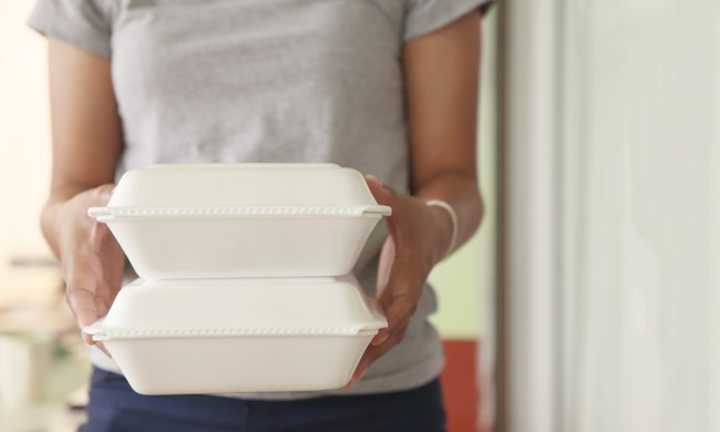 Person holding two Styrofoam carry-out containers