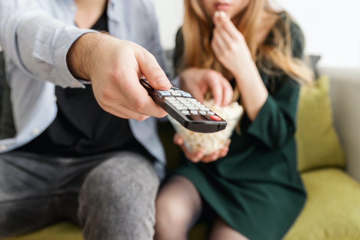 Couple holding a TV remote