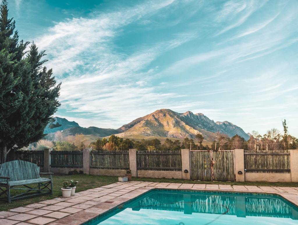 Backyard inground pool mountain background