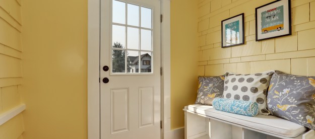 yellow entryway with bench