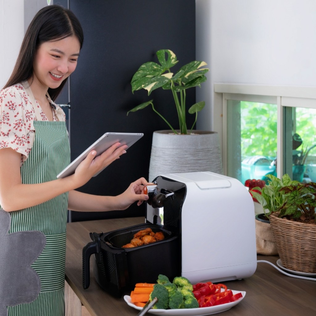 woman cooking with an air fryer