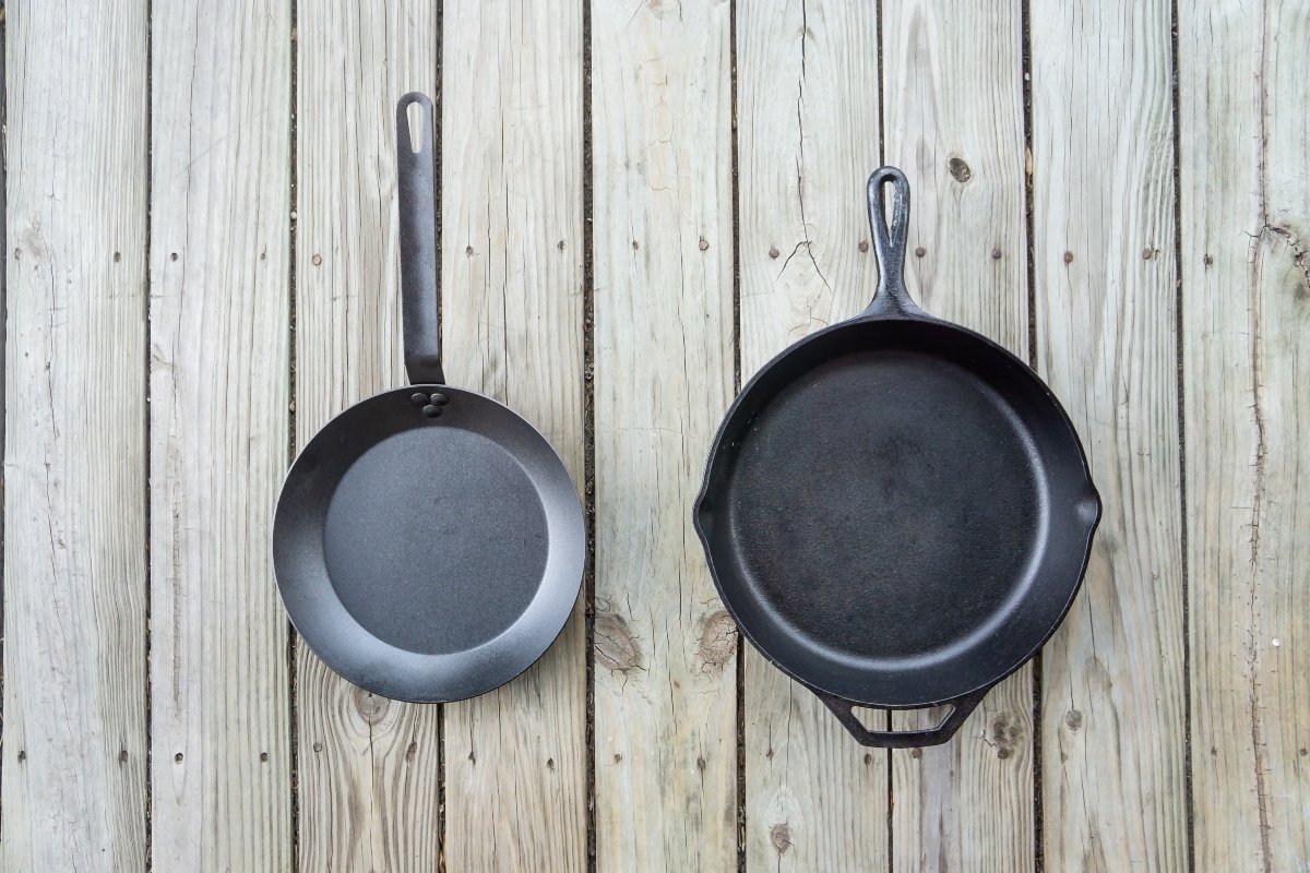 cast iron pan beside carbon steel pan comparison