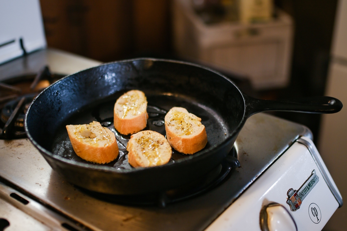 cast iron pan cooking food on the stovetop