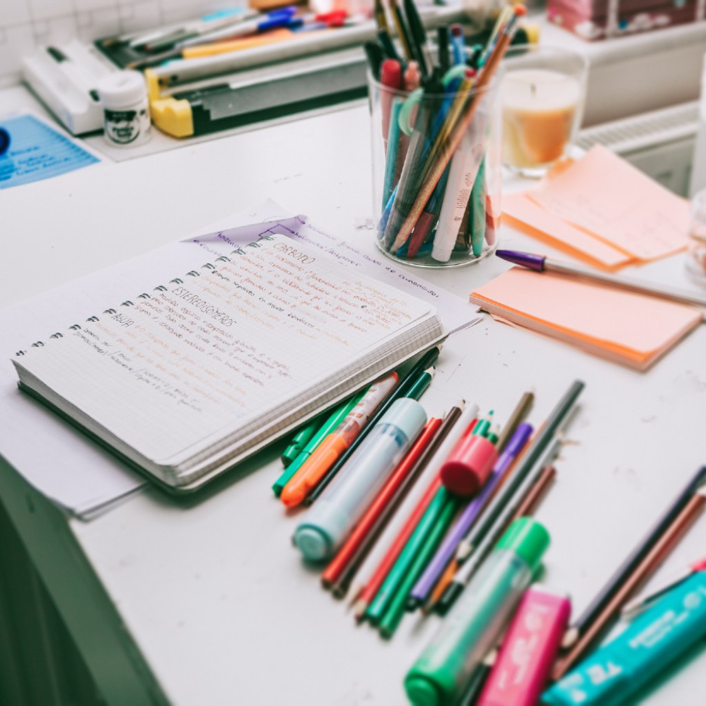 Desk with office supplies scattered about