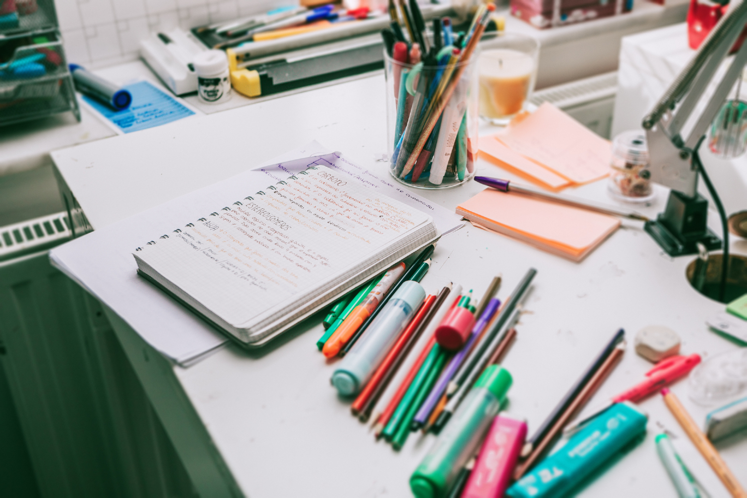 Desk with office supplies scattered about