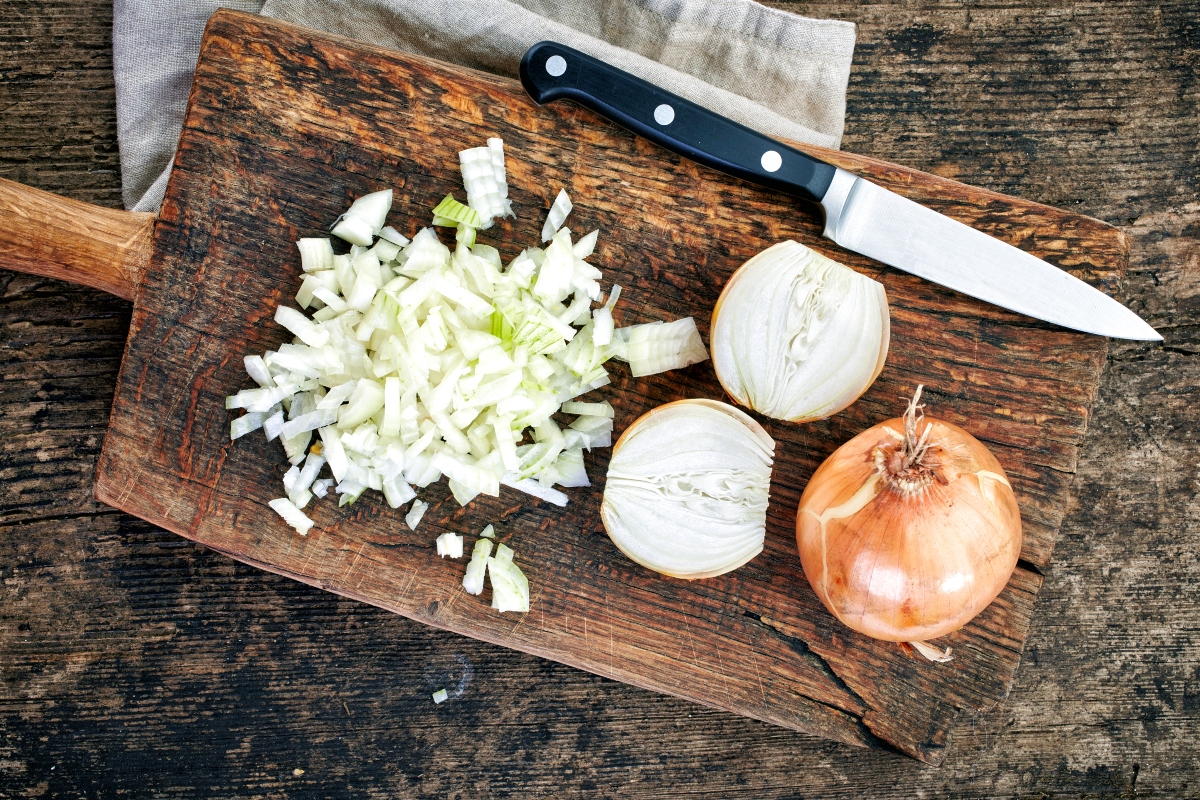 diced onion on cutting board next to knife
