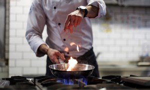 professional chef using carbon steel pan