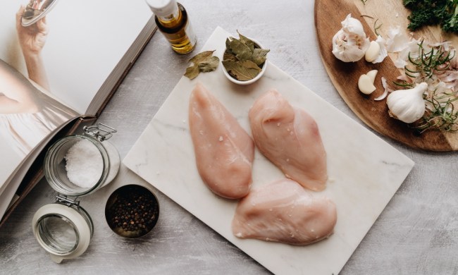 Raw chicken and other ingredients on a cutting board
