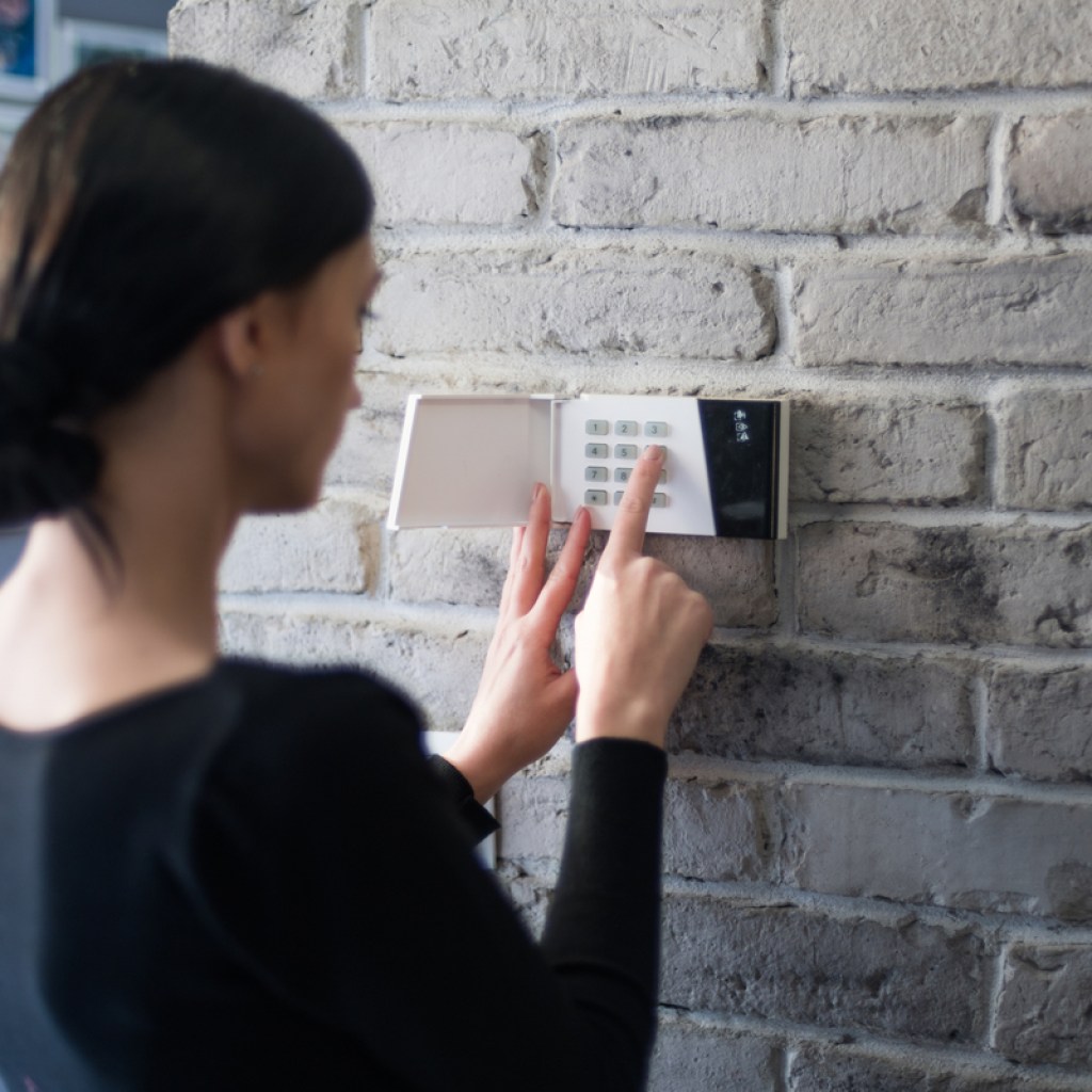 woman setting a security alarm