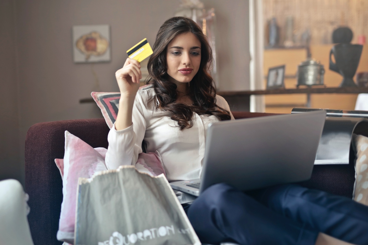 woman with credit card checking credit report