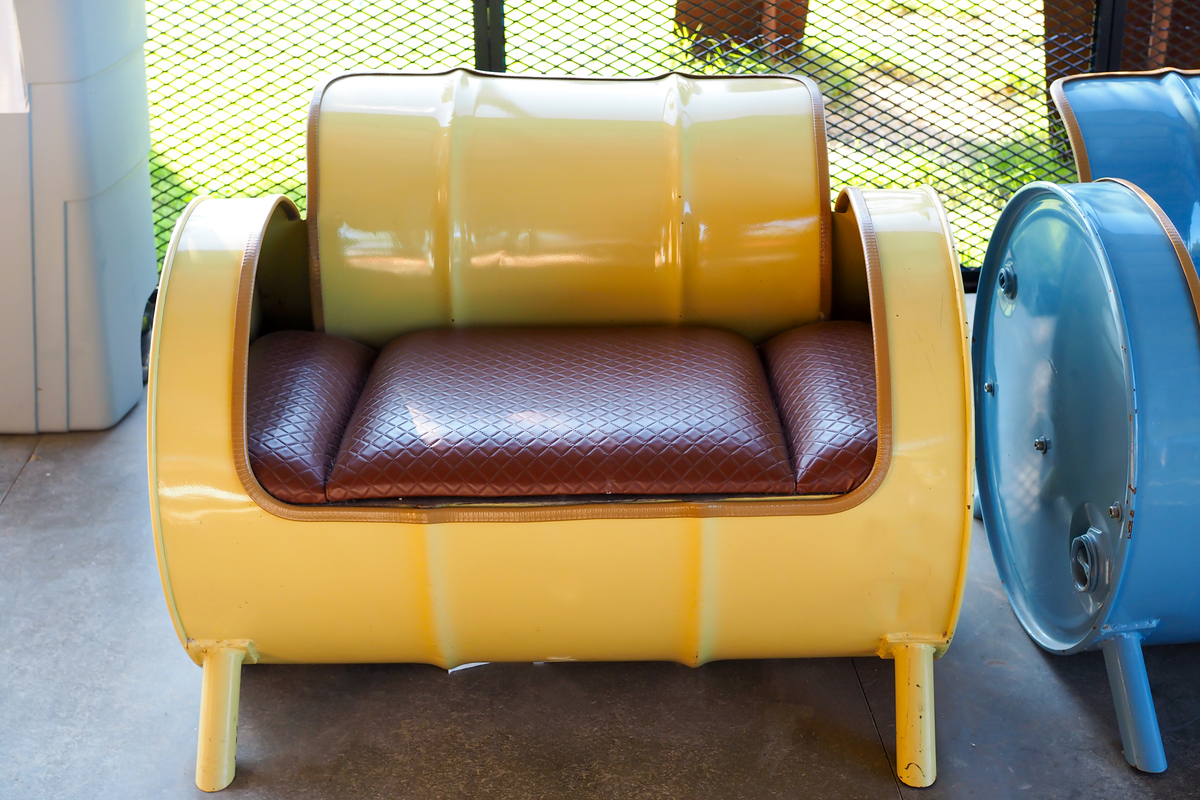 a chair made from a repurposed metal barrel