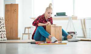woman assembling a wooden box