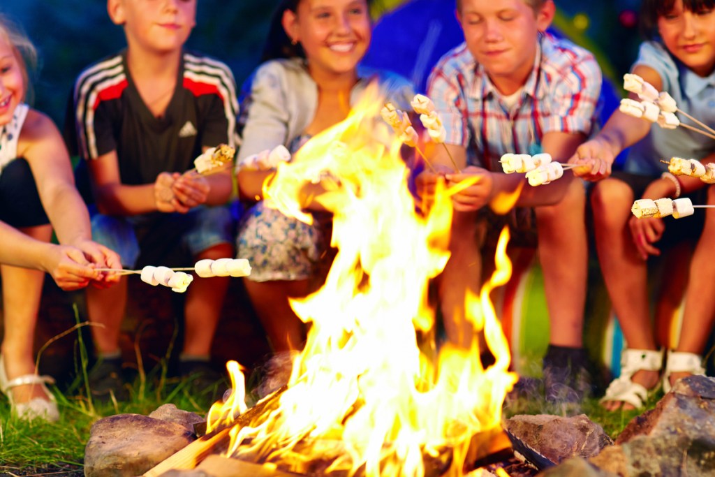 five kids toasting marshmallows