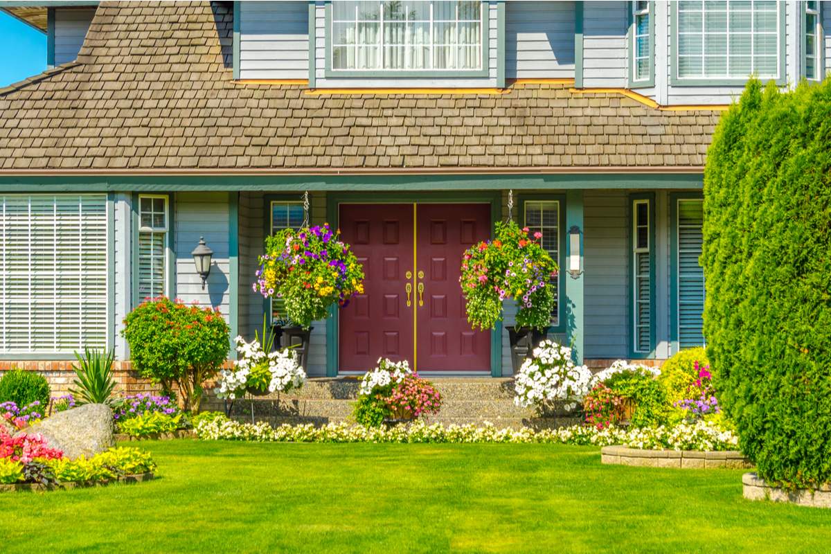 front yard with nice landscaping blue house