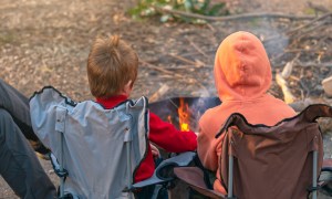two kids by a fire pit