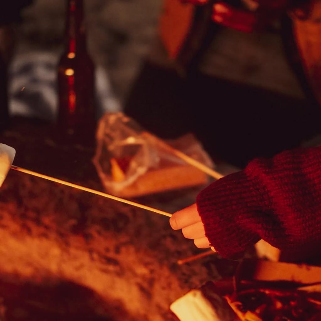 Roasting s'mores around a campfire