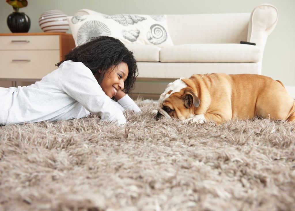 Woman on a rug with her dog