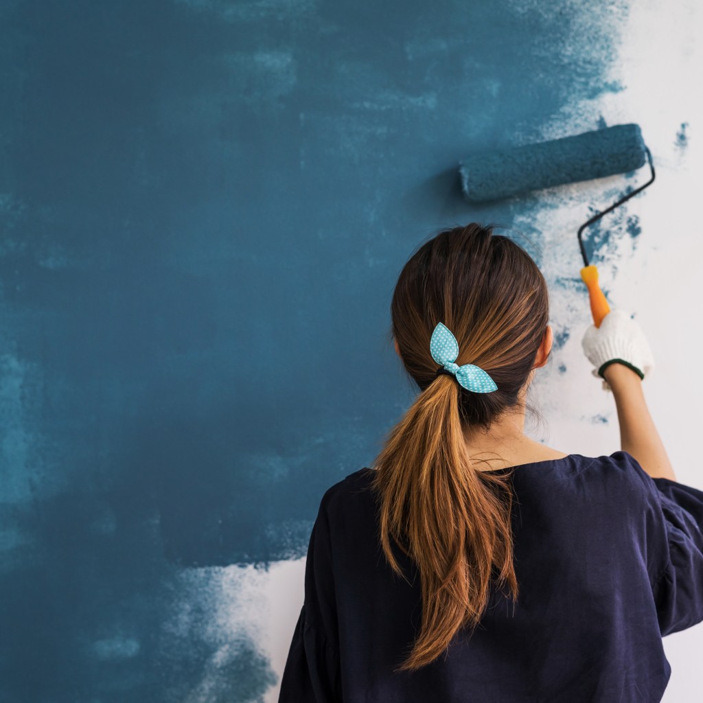 Woman Painting With Paint Roller