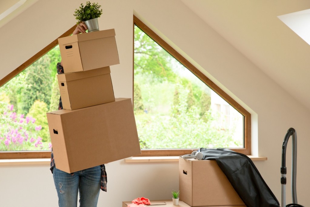 Person organizing boxes in their finished attic