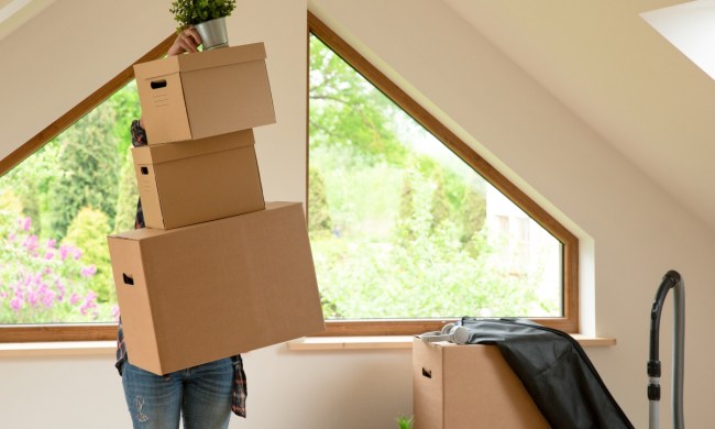 Person organizing boxes in their finished attic