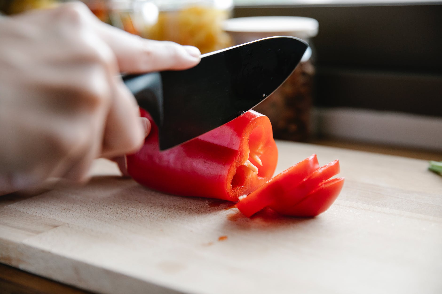 Cutting a red pepper on a cutting board