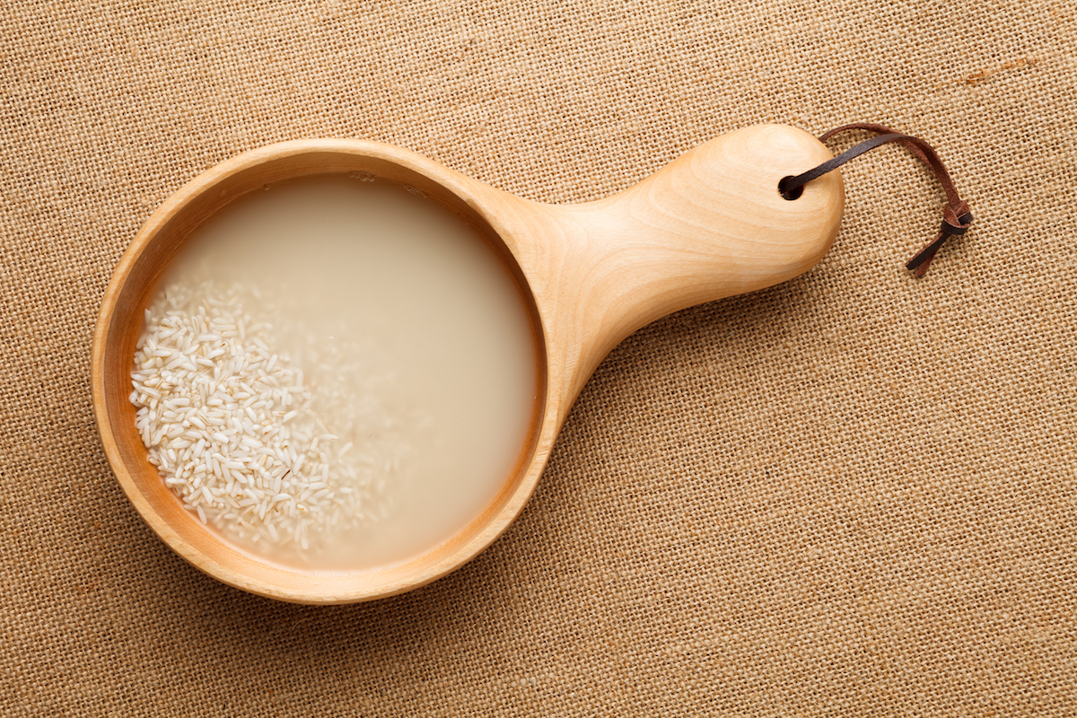 Washing rice in a wooden bowl