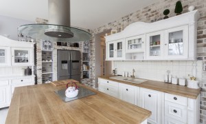 Kitchen with wood countertops and brick backsplash