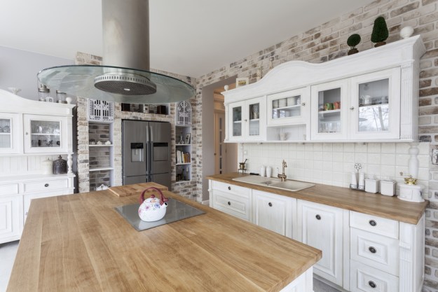 Kitchen with wood countertops and brick backsplash