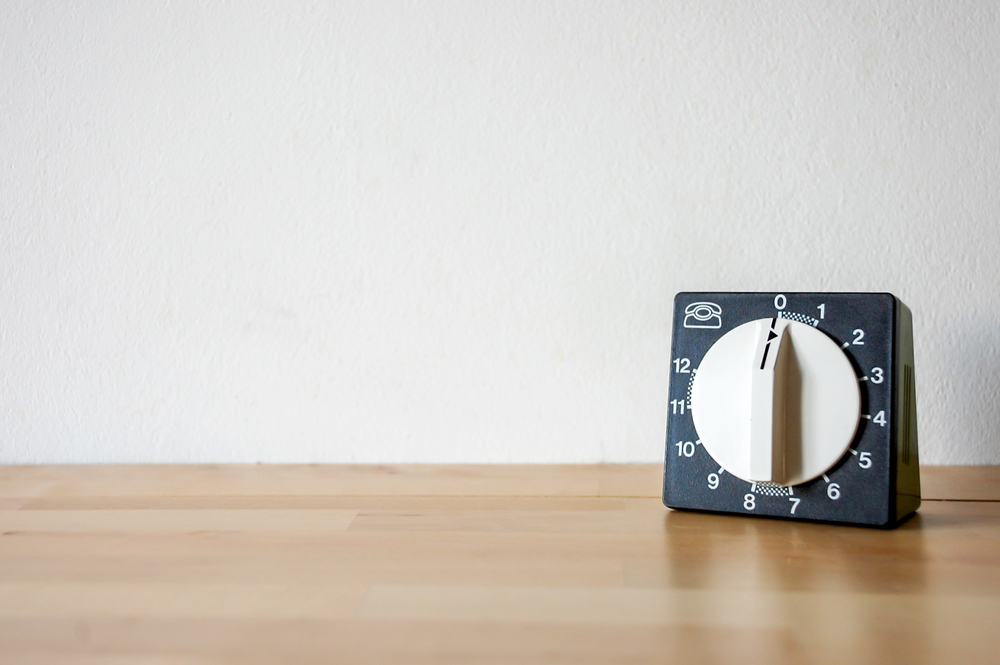 black and white kitchen timer on wood surface