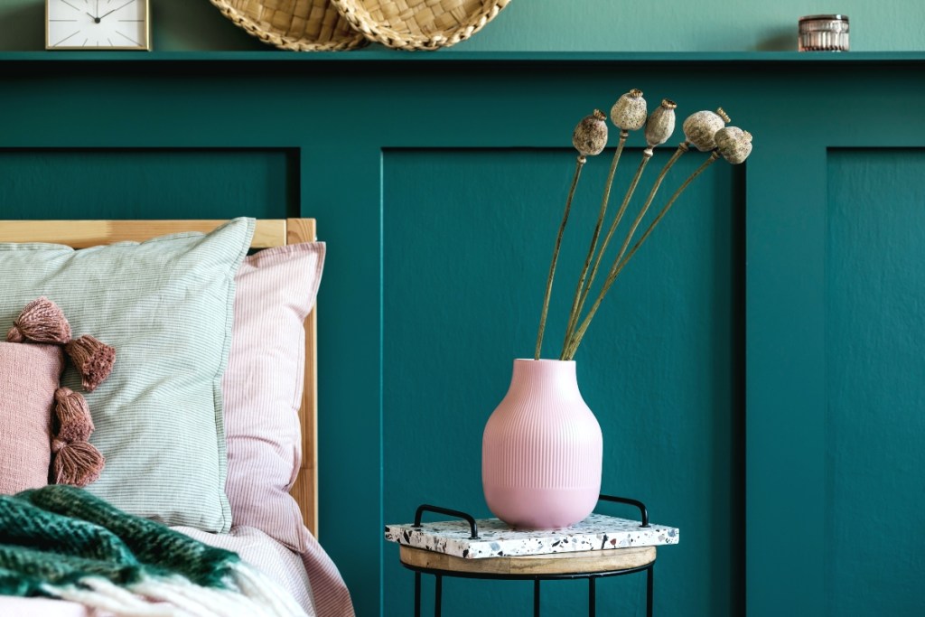 dark green wall paneling in bedroom