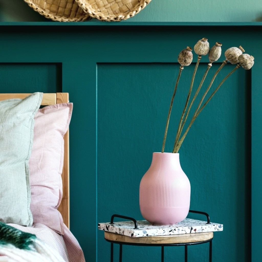 dark green wall paneling in bedroom