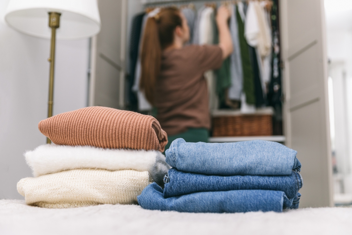 Woman decluttering the clothing in her closet
