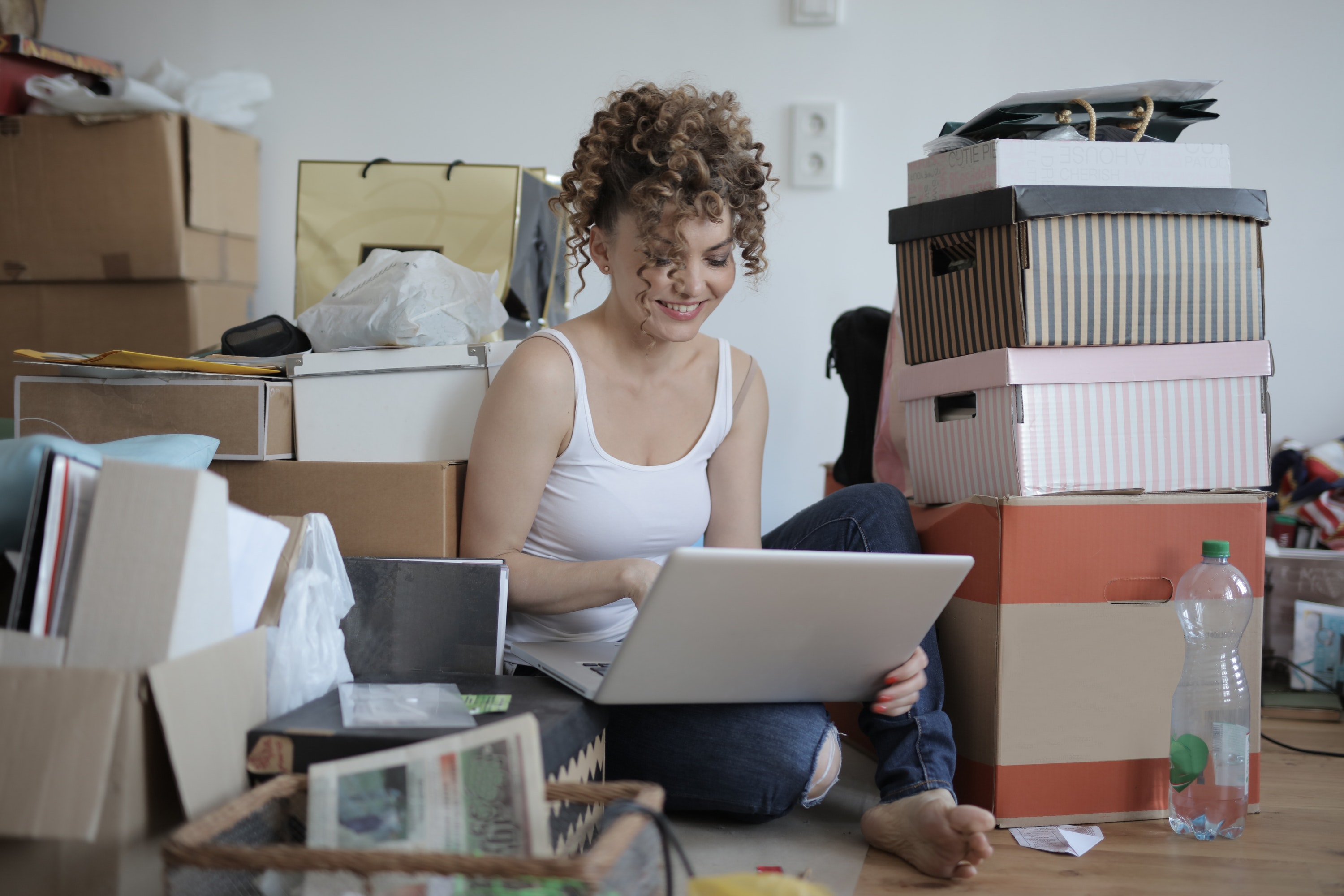 Woman sitting among boxes of clutter
